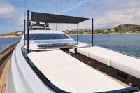 Luxurious 2007 Codecasa 41S yacht with sunbathing deck, anchored near scenic coastline.