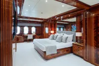Luxurious bedroom interior on 2007 Codecasa 41S yacht with elegant wood paneling.