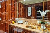 Luxurious yacht bathroom with wood paneling, marble countertop, and gold fixtures, Codecasa 41S, 2007.