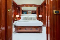 Luxurious bedroom interior on 2007 Codecasa 41S yacht with elegant wood paneling.