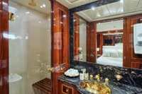 Luxurious yacht bathroom with marble accents, gold fixtures, and elegant wood paneling, Codecasa 41S, 2007.