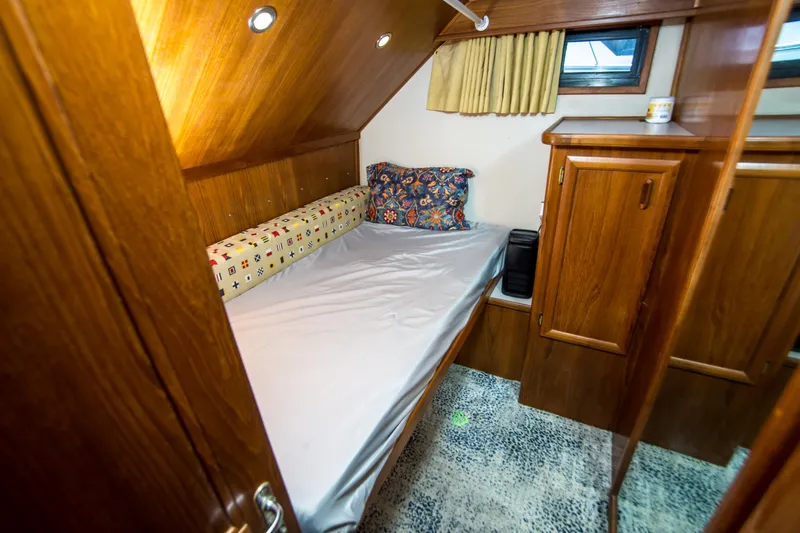 Coda Yacht Photos Pics Cozy cabin interior of 1989 Californian 55 Cockpit Motor Yacht with wooden furnishings.