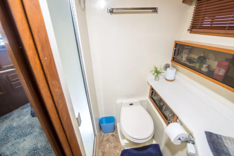 Coda Yacht Photos Pics Bathroom interior of 1989 Californian 55 Cockpit Motor Yacht with shower and storage.