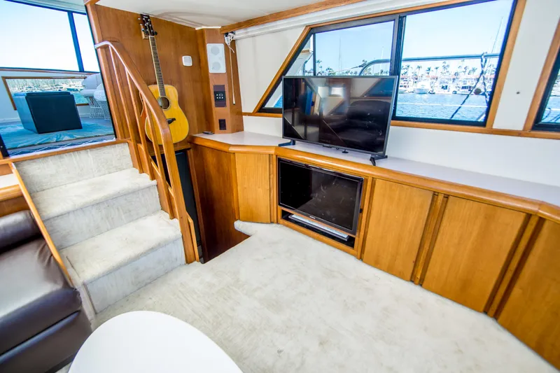 Coda Yacht Photos Pics Interior of 1989 Californian 55 Cockpit Motor Yacht with TV, guitar, and stairs.