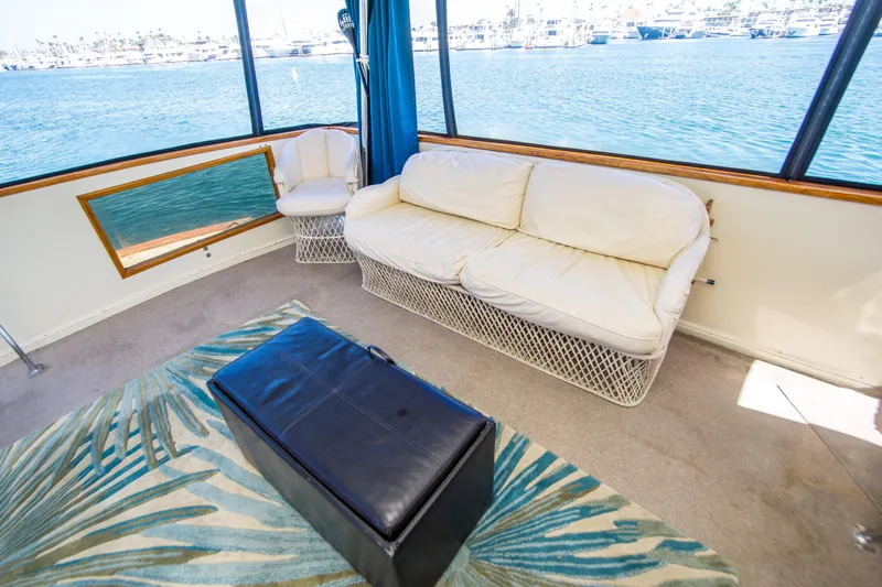 Coda Yacht Photos Pics 1989 Californian 55 Cockpit Motor Yacht interior with white seating, ocean view, and modern decor.