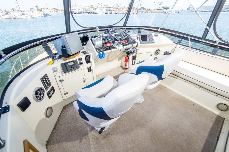 Coda Yacht Photos Pics 1989 Californian 55 Cockpit Motor Yacht helm with dual seats and navigation equipment.