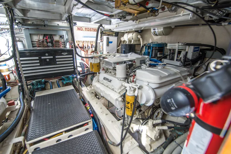 Coda Yacht Photos Pics Engine room of 1989 Californian 55 Cockpit Motor Yacht, featuring detailed mechanical components.