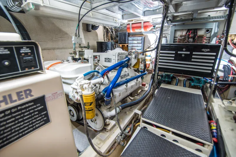 Coda Yacht Photos Pics Engine room of 1989 Californian 55 Cockpit Motor Yacht with visible machinery and tools.