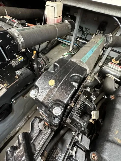 No Tan Lines Yacht Photos Pics Engine compartment of a 2000 Sea Ray 410 Sundancer boat, showcasing mechanical components.