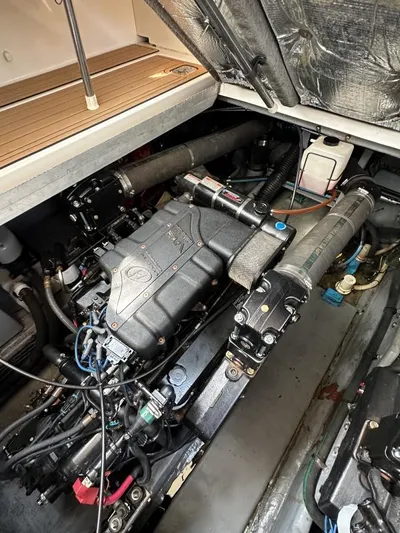 No Tan Lines Yacht Photos Pics Engine compartment of a 2000 Sea Ray 410 Sundancer boat, showcasing mechanical components.