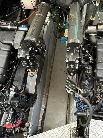 No Tan Lines Yacht Photos Pics Engine compartment of a 2000 Sea Ray 410 Sundancer boat, showcasing mechanical components.