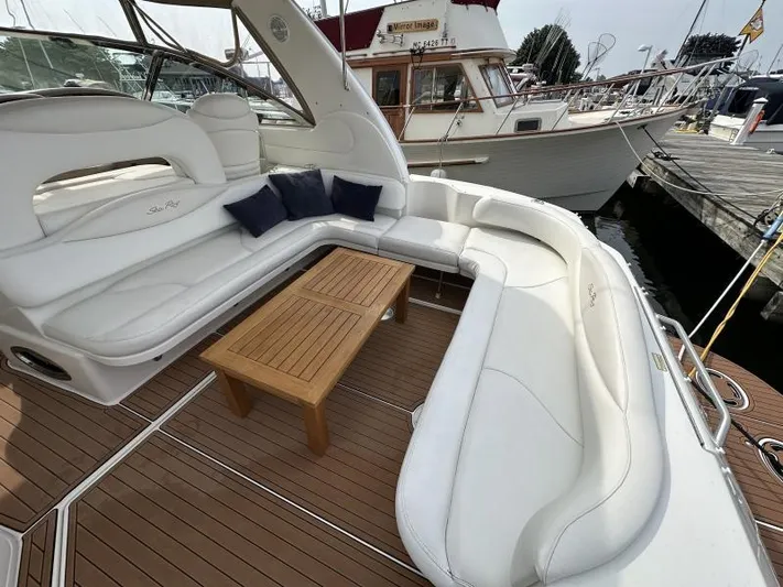 No Tan Lines Yacht Photos Pics Luxurious 2000 Sea Ray 410 Sundancer yacht with spacious white seating and wooden table.
