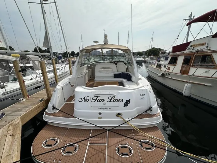 No Tan Lines Yacht Photos Pics Sea Ray 410 Sundancer 2000 docked, rear view with "No Tan Lines" name visible.