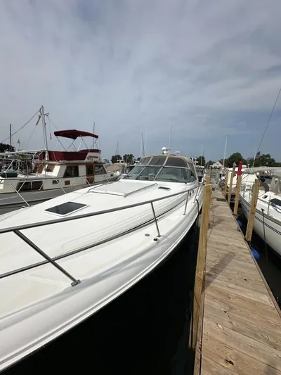 No Tan Lines Yacht Photos Pics 2000 Sea Ray 410 Sundancer docked at marina under cloudy sky.