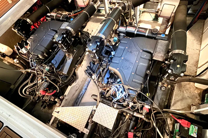 No Tan Lines Yacht Photos Pics Engine room of a 2000 Sea Ray 410 Sundancer boat, showcasing dual engines.