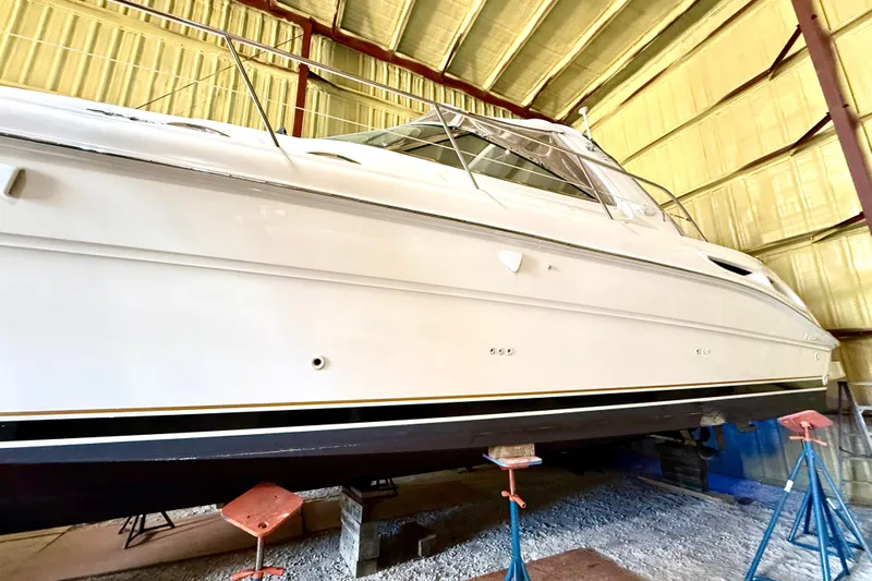 No Tan Lines Yacht Photos Pics 2000 Sea Ray 410 Sundancer yacht in storage, side view, elevated on stands.