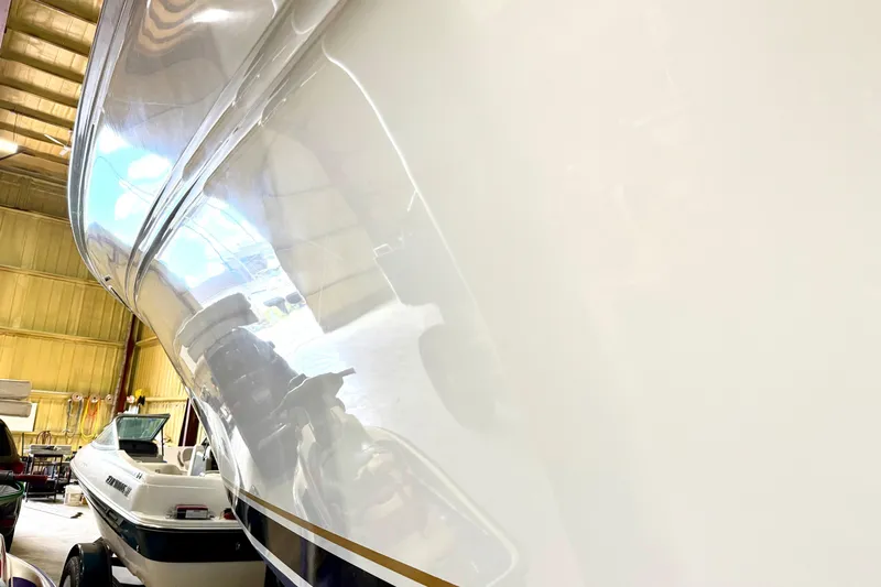 No Tan Lines Yacht Photos Pics 2000 Sea Ray 410 Sundancer boat in a storage facility, showcasing its sleek hull design.