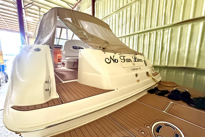 No Tan Lines Yacht Photos Pics 2000 Sea Ray 410 Sundancer yacht in storage, featuring teak deck and covered seating area.