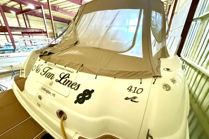 No Tan Lines Yacht Photos Pics 2000 Sea Ray 410 Sundancer boat in storage, featuring tan cover and "No Tan Lines" text.