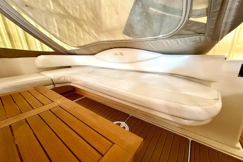 No Tan Lines Yacht Photos Pics Luxurious interior of 2000 Sea Ray 410 Sundancer with white seating and wooden table.