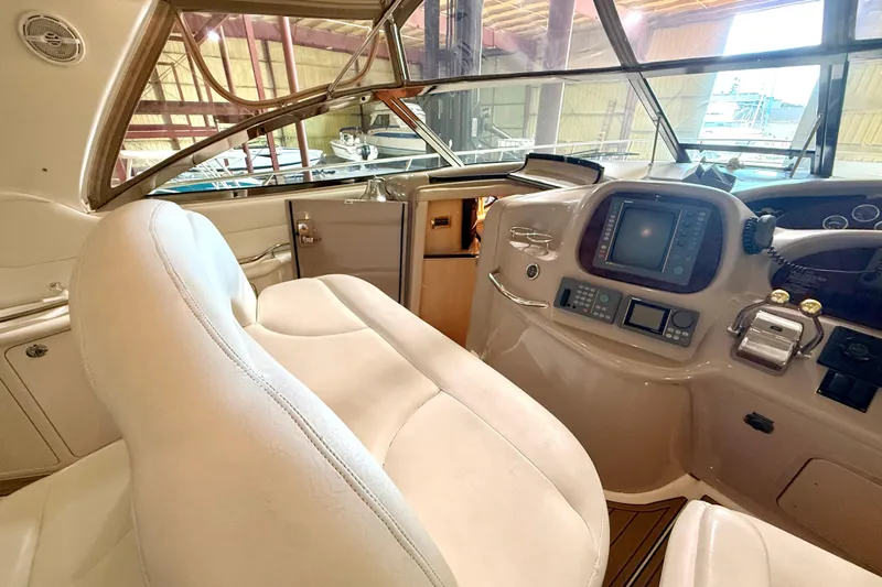 No Tan Lines Yacht Photos Pics Interior cockpit of 2000 Sea Ray 410 Sundancer with white seating and navigation controls.