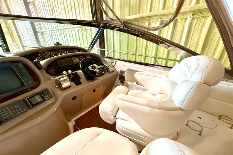 No Tan Lines Yacht Photos Pics Interior cockpit of 2000 Sea Ray 410 Sundancer with steering wheel and controls.