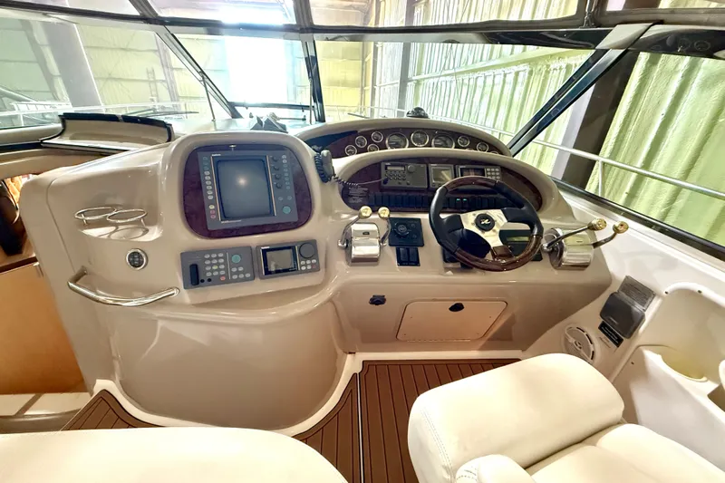 No Tan Lines Yacht Photos Pics Cockpit of 2000 Sea Ray 410 Sundancer with steering wheel and navigation controls.