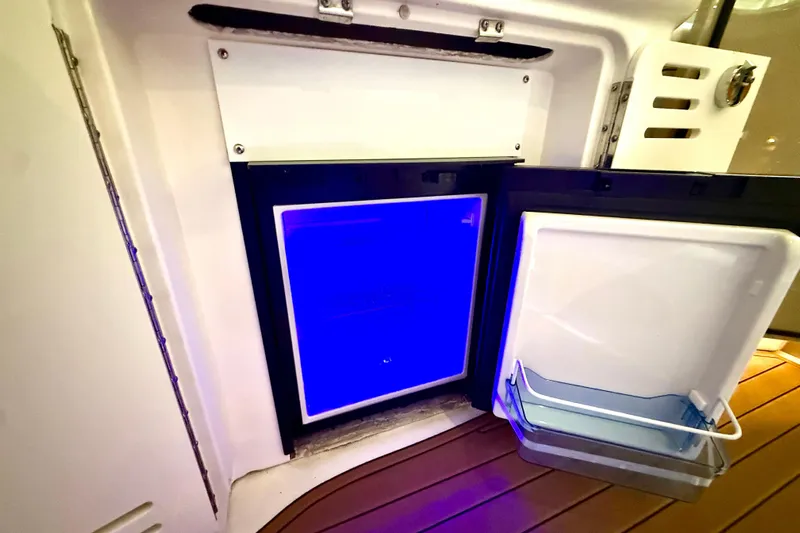 No Tan Lines Yacht Photos Pics Open mini fridge with blue interior light on 2000 Sea Ray 410 Sundancer boat.