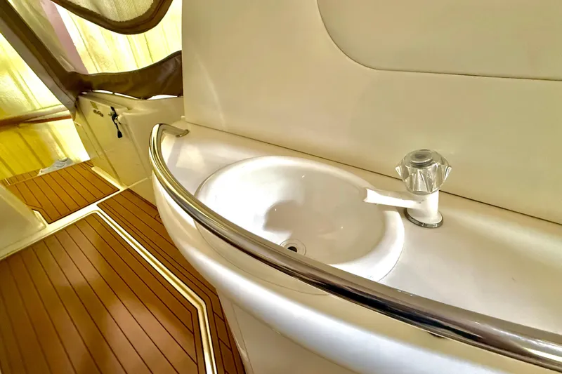 No Tan Lines Yacht Photos Pics Interior of 2000 Sea Ray 410 Sundancer yacht with sink and wooden flooring.