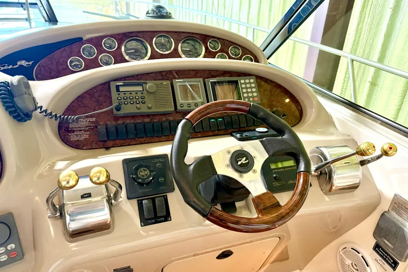 No Tan Lines Yacht Photos Pics Cockpit of 2000 Sea Ray 410 Sundancer with steering wheel and control panel.