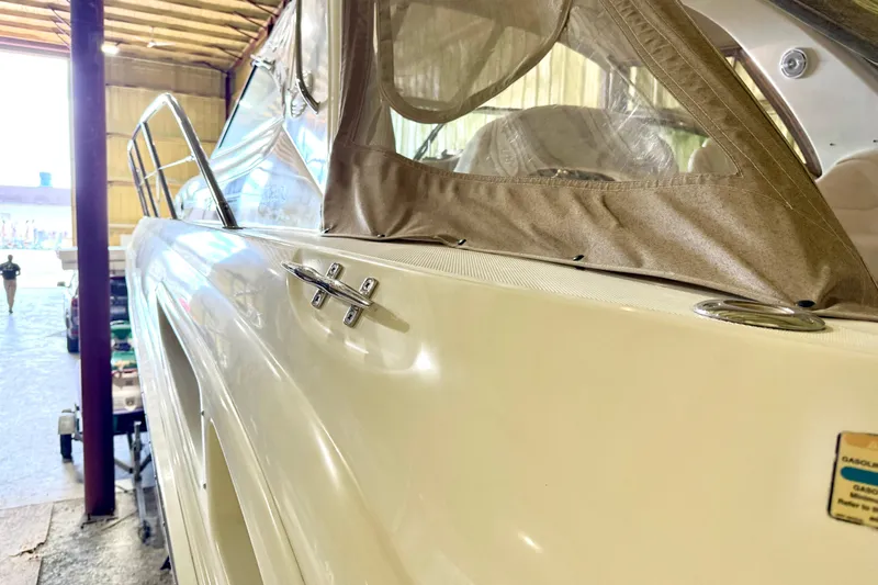 No Tan Lines Yacht Photos Pics 2000 Sea Ray 410 Sundancer yacht in storage, showcasing sleek design and beige canopy.