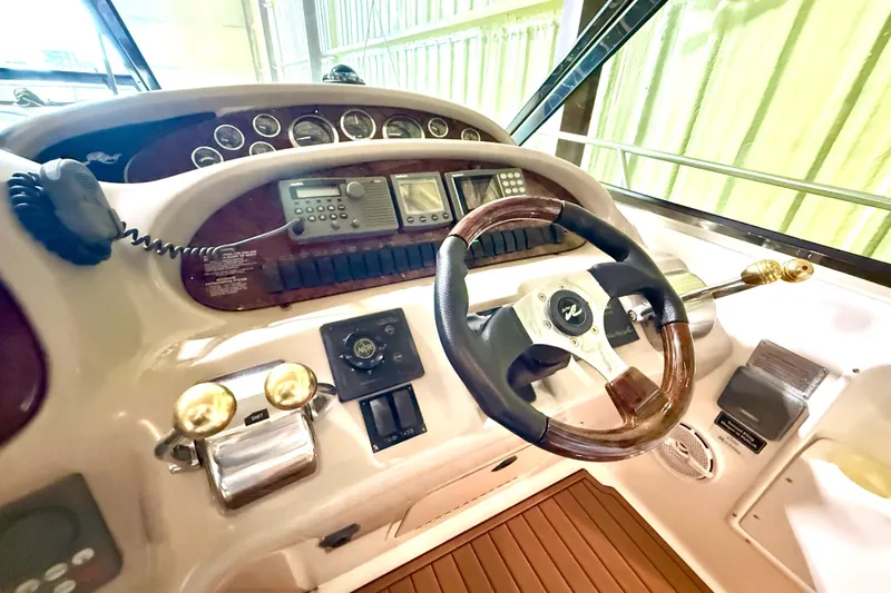 No Tan Lines Yacht Photos Pics Cockpit of 2000 Sea Ray 410 Sundancer with steering wheel and control panel.