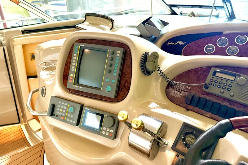 No Tan Lines Yacht Photos Pics Cockpit of 2000 Sea Ray 410 Sundancer with navigation equipment and controls.