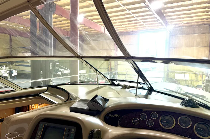 No Tan Lines Yacht Photos Pics Interior view of 2000 Sea Ray 410 Sundancer yacht cockpit in a boat storage facility.