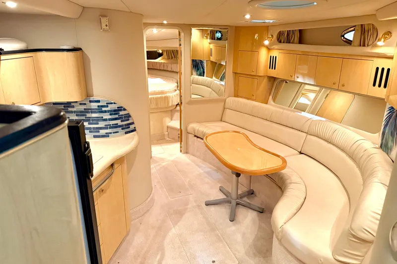 No Tan Lines Yacht Photos Pics Luxurious interior of 2000 Sea Ray 410 Sundancer yacht with elegant seating and modern design.
