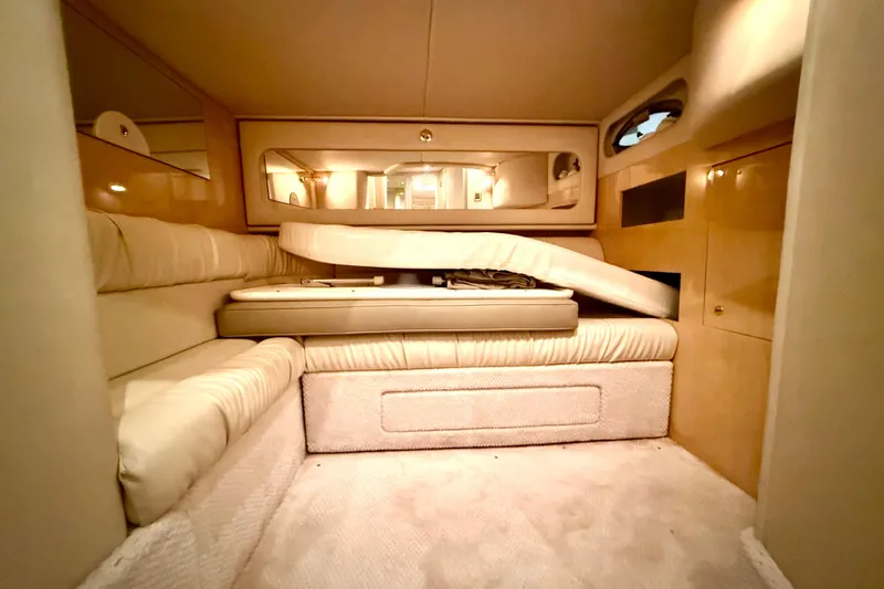 No Tan Lines Yacht Photos Pics Interior cabin of 2000 Sea Ray 410 Sundancer yacht, featuring beige upholstery and wood accents.