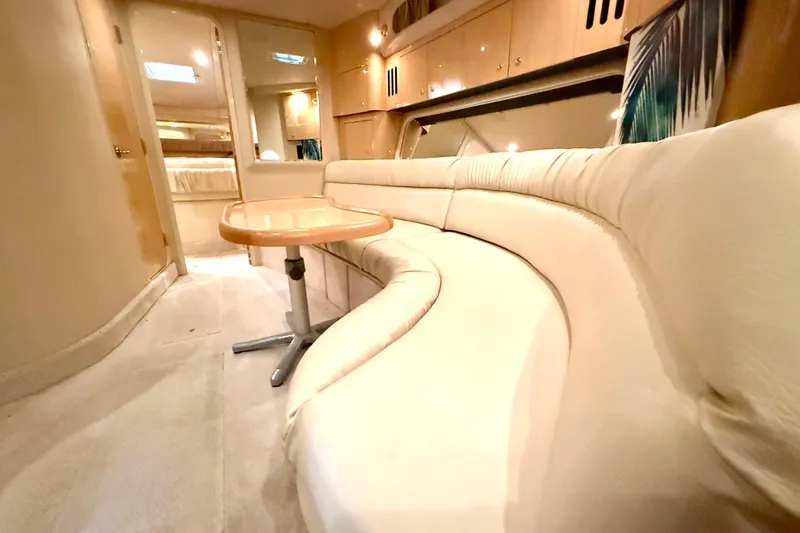No Tan Lines Yacht Photos Pics Luxurious interior of 2000 Sea Ray 410 Sundancer yacht with plush seating and elegant table.