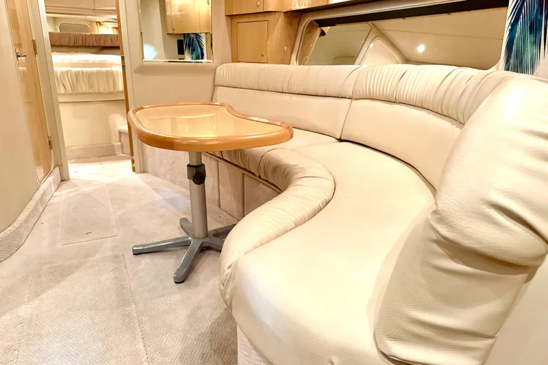 No Tan Lines Yacht Photos Pics Luxurious interior of 2000 Sea Ray 410 Sundancer yacht with plush seating and table.