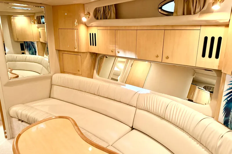 No Tan Lines Yacht Photos Pics Luxurious interior of 2000 Sea Ray 410 Sundancer yacht with cream leather seating.