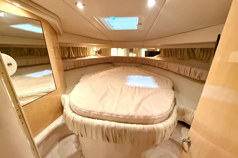 No Tan Lines Yacht Photos Pics Luxurious interior cabin of 2000 Sea Ray 410 Sundancer yacht with plush bedding.