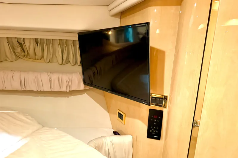 No Tan Lines Yacht Photos Pics Interior of 2000 Sea Ray 410 Sundancer with mounted TV and luxurious furnishings.