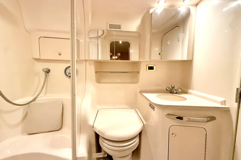 No Tan Lines Yacht Photos Pics Luxurious bathroom in 2000 Sea Ray 410 Sundancer yacht, featuring modern fixtures and elegant design.