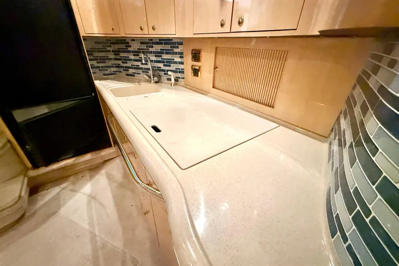 No Tan Lines Yacht Photos Pics Luxurious kitchen area in a 2000 Sea Ray 410 Sundancer yacht with modern backsplash.