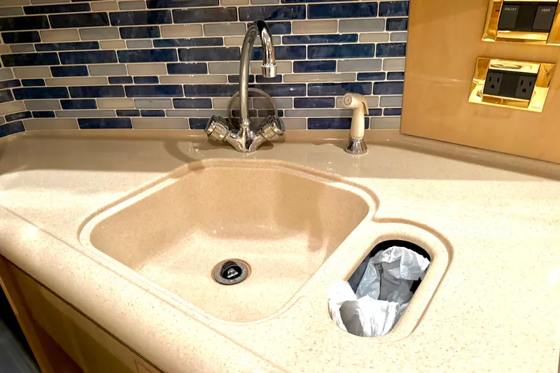 No Tan Lines Yacht Photos Pics Kitchen sink area on a 2000 Sea Ray 410 Sundancer yacht with modern backsplash.