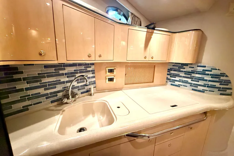 No Tan Lines Yacht Photos Pics Luxurious kitchen area in a 2000 Sea Ray 410 Sundancer yacht with modern cabinetry.