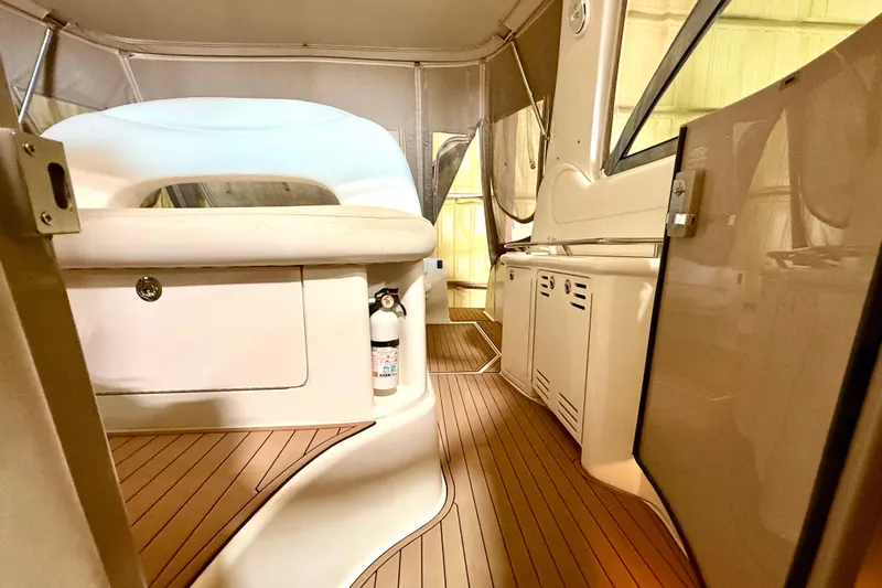 No Tan Lines Yacht Photos Pics Interior view of 2000 Sea Ray 410 Sundancer yacht with teak flooring and seating area.