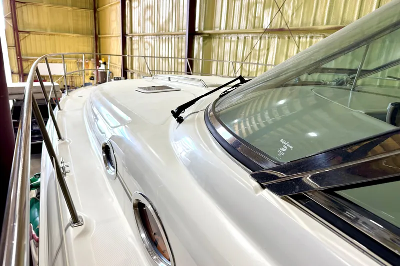 No Tan Lines Yacht Photos Pics 2000 Sea Ray 410 Sundancer yacht in storage, showcasing sleek design and windshield.