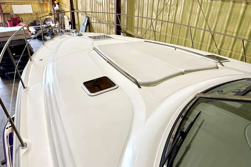 No Tan Lines Yacht Photos Pics 2000 Sea Ray 410 Sundancer yacht deck in storage, showcasing sleek design and railings.