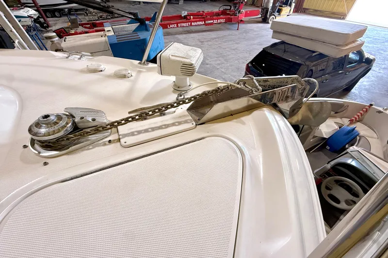 No Tan Lines Yacht Photos Pics 2000 Sea Ray 410 Sundancer anchor and chain mechanism in a marina setting.
