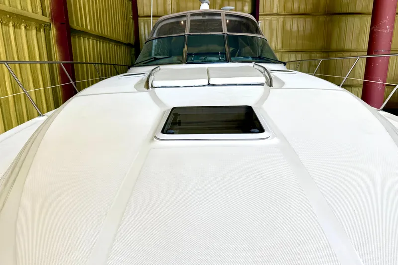 No Tan Lines Yacht Photos Pics 2000 Sea Ray 410 Sundancer yacht in storage, showcasing sleek design and spacious deck.